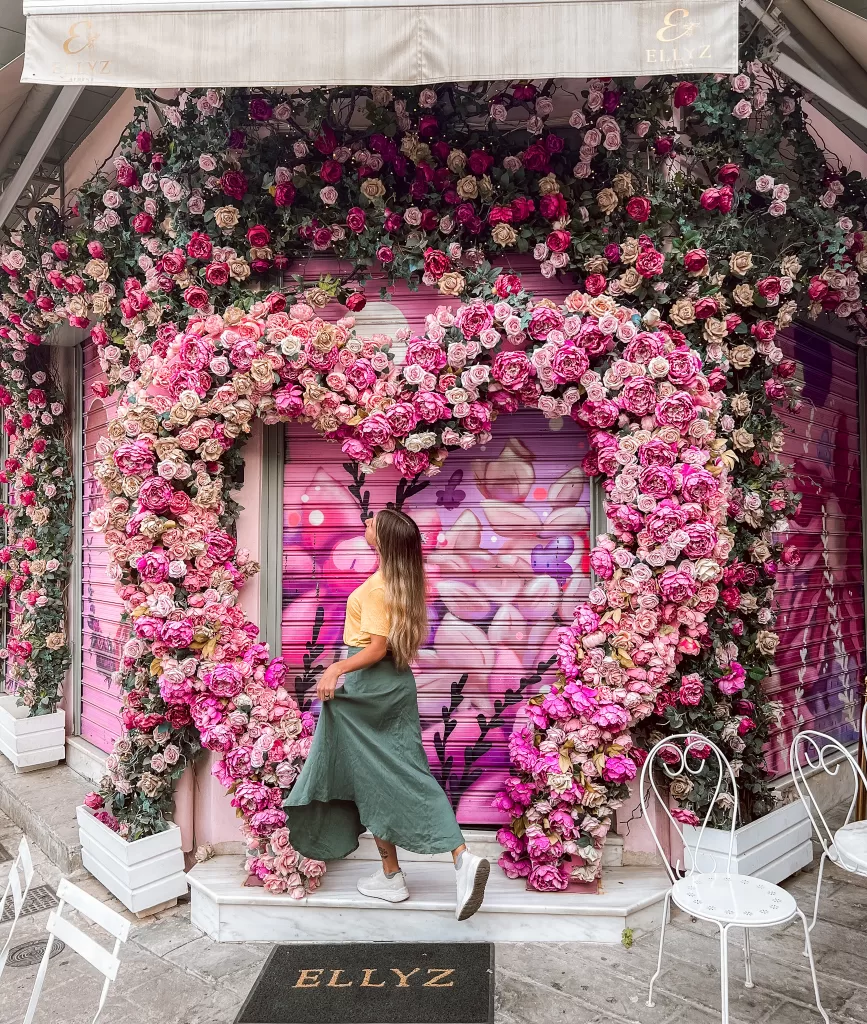 Pink cafe with a large heart made of pink flowers in Athens